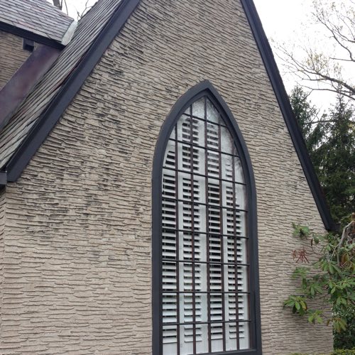 outdoor facade of brick home with plantation shutters